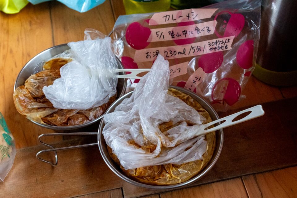 ガスが抜けるかもしれないからしばらくここで待つことにして早めのお昼ごはん。荷物の容量を減らすため、容器から出してポリ袋に入れてたカレーメシをシェラカップにセット。メモのとおり作る。